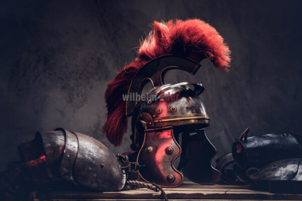 Complete combat equipment of the ancient Greek warrior lie on a box of wooden boards. Isolated on a dark background.